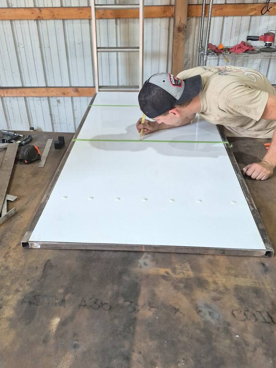 Flat panel laid out and marked on the Pro-Line shop floor before cutting