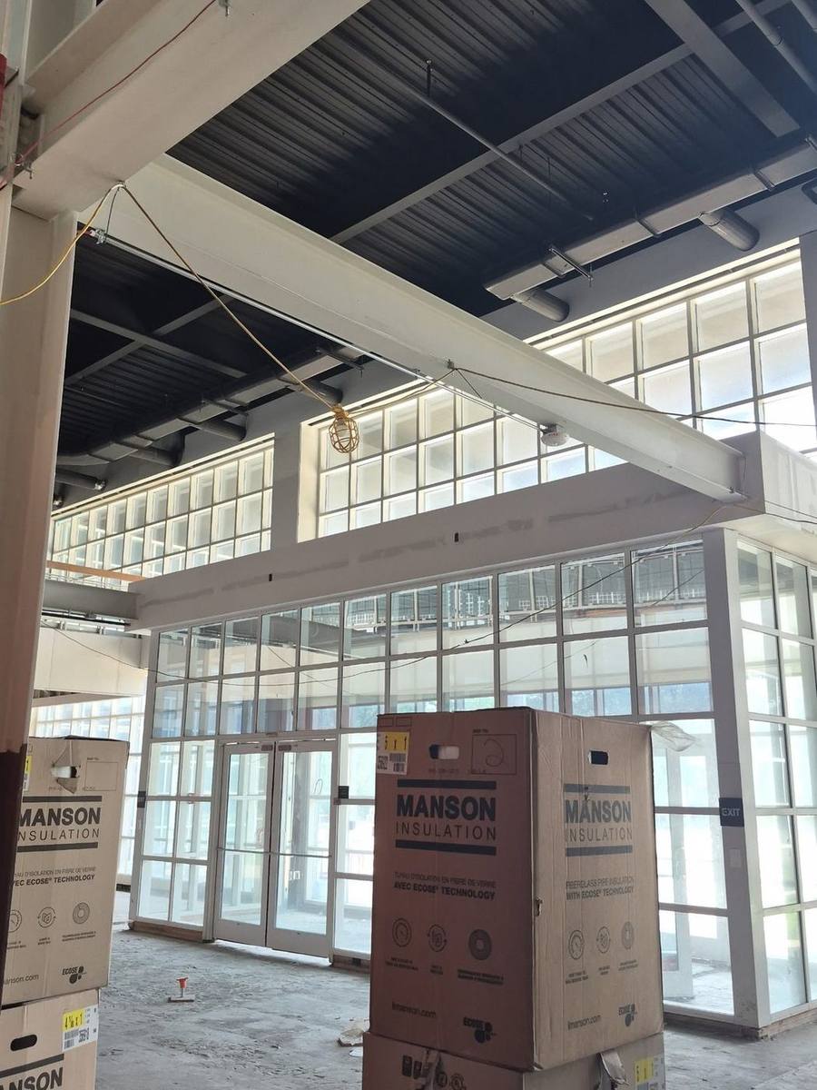 Structural steel beam and a steel mezzanine railing installed in a commercial building under construction