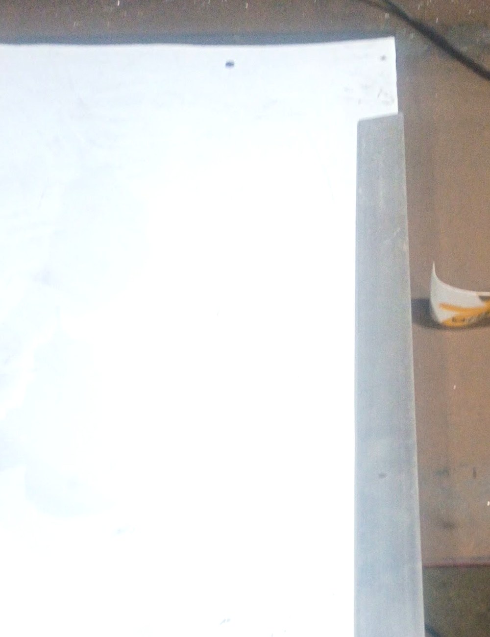 Aluminum plate clamped on the bench with a grinder alongside in the Pro-Line shop