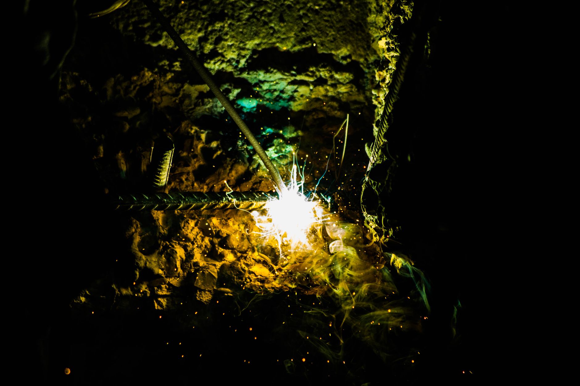Welding sparks in a dark industrial setting